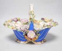 A Rockingham type floral encrusted china basket, 32cm