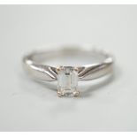 A 750 white metal and solitaire emerald cut diamond ring, size J/k, gross weight 2.9 grams.