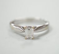 A 750 white metal and solitaire emerald cut diamond ring, size J/k, gross weight 2.9 grams.