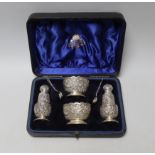 A cased late Victorian Anglo Indian style four piece silver condiment set with two matching
