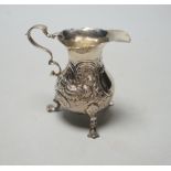A George II silver cream jug, with later embossed decoration, marks rubbed, London, 1750? (a.f.),