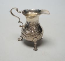 A George II silver cream jug, with later embossed decoration, marks rubbed, London, 1750? (a.f.),