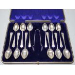 A cased set of twelve pierced silver teaspoons and tongs, John Sanderson, Sheffield, 1907.