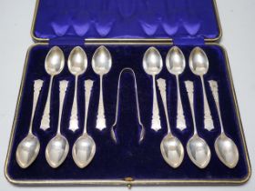 A cased set of twelve pierced silver teaspoons and tongs, John Sanderson, Sheffield, 1907.