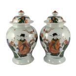 A pair of Chinese famille verte ‘Sanxing’ vases and covers, 19th century, each well painted with the