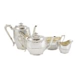 A late Victorian demi fluted silver four piece tea and coffee set, by Wakely & Wheeler, with