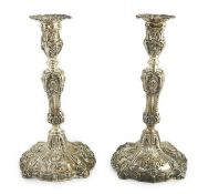 An ornate pair of early Victorian silver candlesticks by Creswick & Co, with waisted stems and