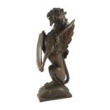 A 16th century Dutch carved oak model of a griffin rampant holding a shield, on domed base, 23cm