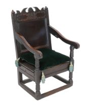 A Charles II oak armchair, of small proportions, monogrammed AM and dated 1682, the seat fitted with