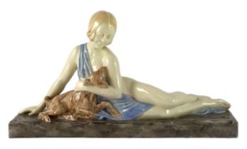 Armand Godard (French, 1824-1887). An Art Deco ceramic group of a reclining beauty with a kid,