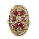 A modern gold, ruby and diamond set oval cluster ring, the central diamond bordered by brilliants