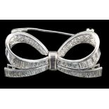 A modern white gold and round and baguette cut diamond cluster set ribbon bow brooch, width 39mm,