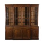 An early Victorian mahogany breakfront library bookcase with moulded cornice and four astragal