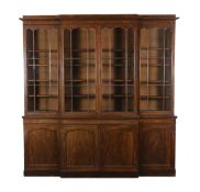 An early Victorian mahogany breakfront library bookcase with moulded cornice and four astragal