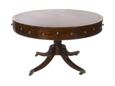 A Regency mahogany drum top library table, the circular top with burgundy leather skiver, four