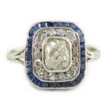 An Art Deco platinum, diamond and sapphire set rectangular cluster ring, the central oval cushion