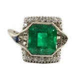 An Art Deco 18k white gold, emerald and diamond set square cluster dress ring, with shaped cut