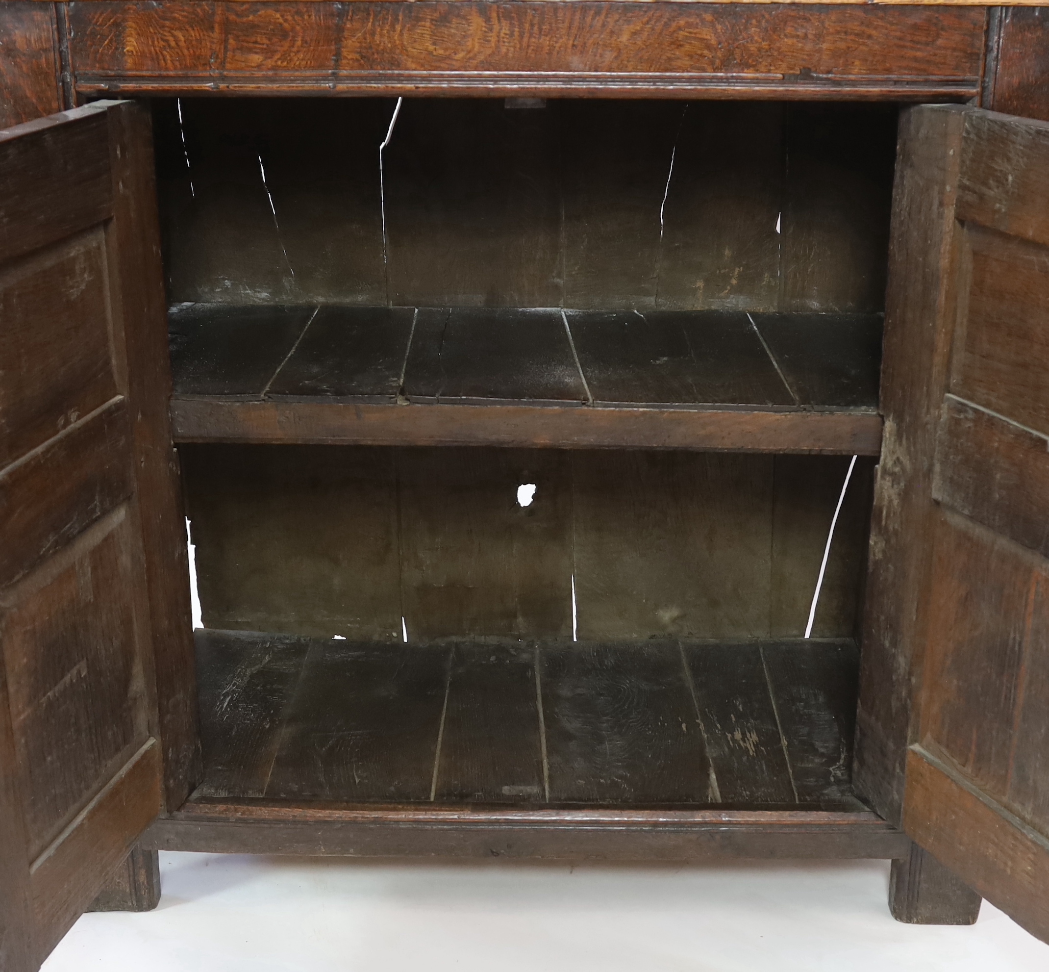 A 17th century oak court cupboard with moulded top and two panelled doors over two further - Image 2 of 4