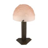 A Muller Freres Art Deco wrought iron and frosted pink glass table lamp, the domed shade moulded