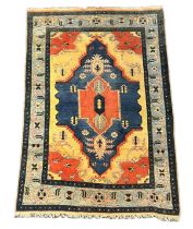 A Kazak rug, the central stepped lozenge medallion within a geometric field and wide conforming