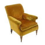 A late Victorian Howard & Sons upholstered armchair, now with later golden velvet upholstery, on