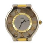A modern Must de Cartier steel and gold plated quartz travelling timepiece, with cabochon set winder