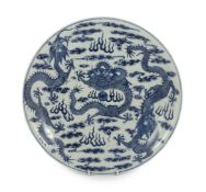 A Chinese blue and white ‘dragon’ dish, Kangxi mark, 19th century, finely painted with a central