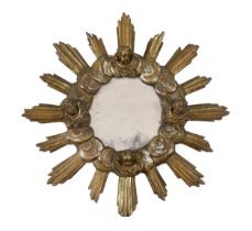 A Baroque Revival silvered and giltwood sunburst wall mirror with cherubs head’s decorations, 78cm