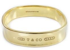 A modern heavy Tiffany & Co 18ct gold shaped bangle, exterior diameter 65mm, 82.2 grams, no box.***