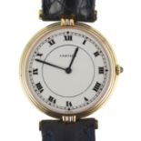 A lady's modern Cartier 18k gold quartz wrist watch, on associated leather strap and buckle, with