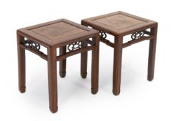 A pair of Chinese hongmu square stands, 19th century, the panelled and framed tops above shaped