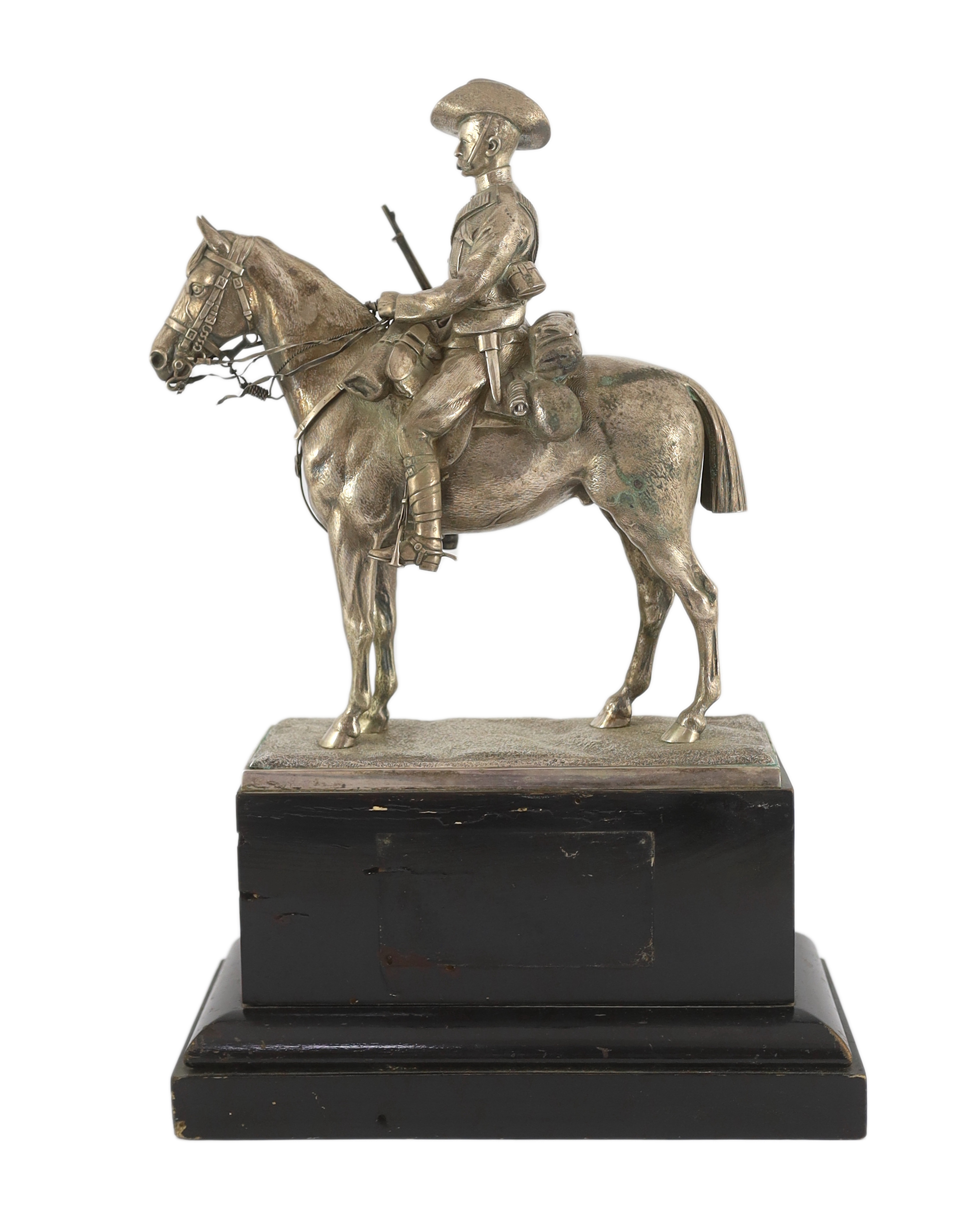 An early 20th century silver model of a City Imperial Volunteer, holding a rifle, on horseback