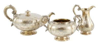A Victorian silver three piece melon shaped tea set, by Charles Reily & George Storer, with engraved