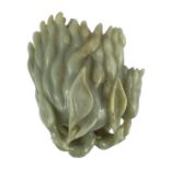 A Chinese celadon jade carving of a finger citron, 20th century, the stone with occasional white and
