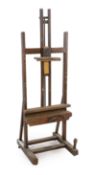 A Winsor & Newton oak studio easel with cast brass plaque ‘Studio Easel, Winsor & Newton, Ltd,