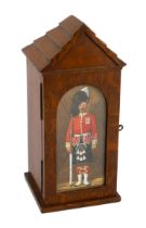 A late Victorian oak smoker’s cabinet modelled as a sentry box with a watercolour panel by Richard