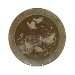 A Japanese Komai style mixed metal inlaid bronze dish, Meiji period, decorated with cranes by a