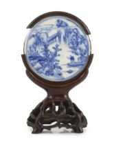 A Chinese blue and white porcelain circular plaque, possibly 17th century, finely painted with a