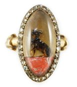 An early Victorian gold and rose cut diamond set Essex crystal oval ring, depicting a seated dog