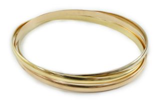 A modern three colour 18ct gold Cartier Russian triple bangle, signed and numbered B46436, 30.6