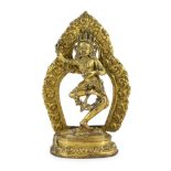 A Tibetan gilt bronze figure of Vajrayogini, possibly 17th/18th century, the figure dancing on a