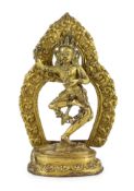 A Tibetan gilt bronze figure of Vajrayogini, possibly 17th/18th century, the figure dancing on a