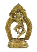 A Tibetan gilt bronze figure of Vajrayogini, possibly 17th/18th century, the figure dancing on a