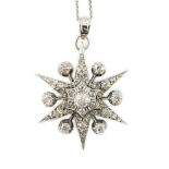 A Victorian white gold and diamond cluster set star burst pendant, on a later sterling chain,