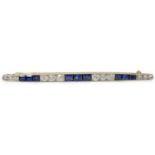 An Art Deco, round cut diamond and rectangular cut sapphire cluster bar brooch, set with twelve