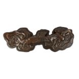 A giant Chinese burrwood 'lingzhi fungus' brush rest, Qing dynasty, carved in relief with ruyi