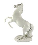 A large Meissen figure of a rearing stallion modelled by Eric Oehme, c.1949, signed, impressed