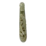 A large Chinese pale celadon jade ‘dragon’ belt hook, 18th/19th century, typically carved and