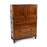 A Victorian teak campaign chest with press cupboard with two panelled doors enclosing a single shelf