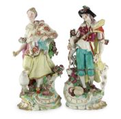 A pair of Chelsea porcelain groups of a shepherd and shepherdess, c.1760-65, the figure of the